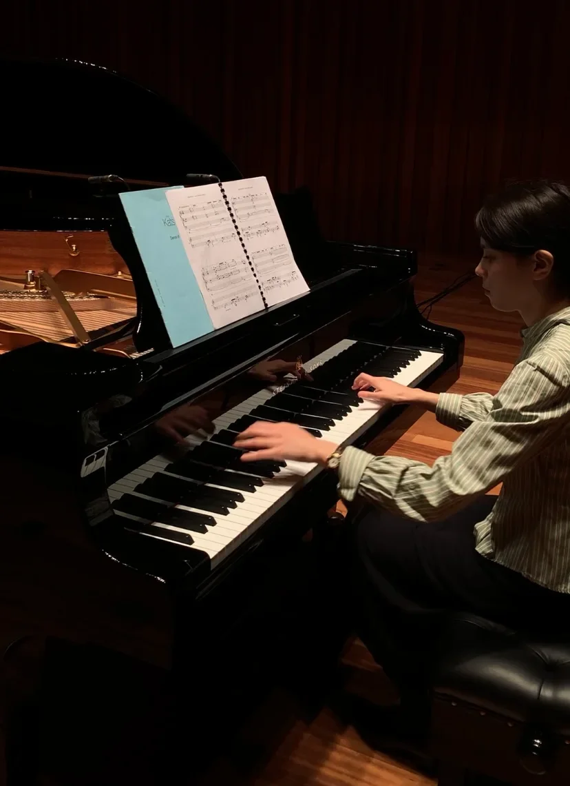 Close-up of hands practicing finger exercises on a piano