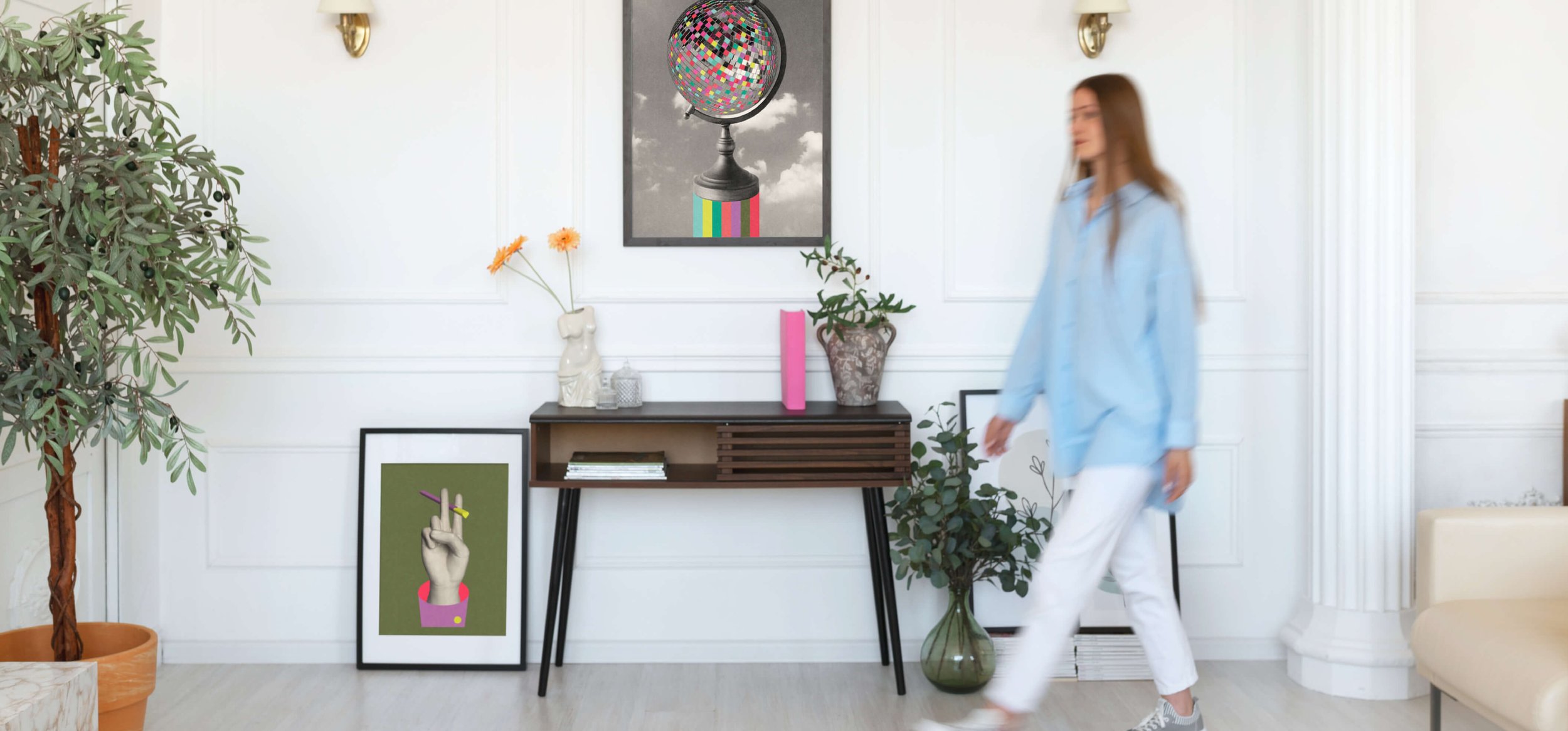 A woman walking past a modern decorated living room with artworks, Let's Dance and Peaceseeker by graphic artist Paul Scott. 
