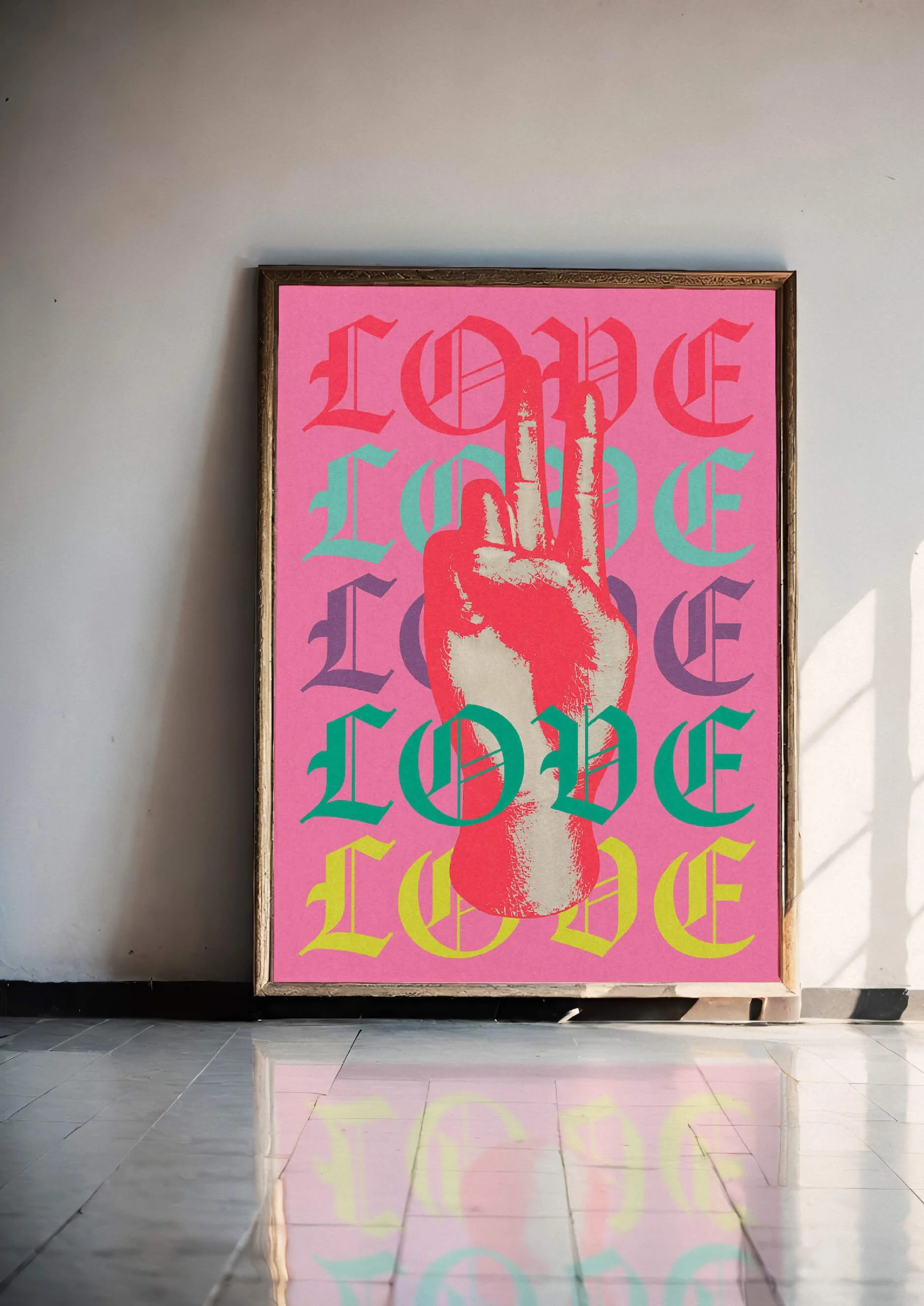 A colorful framed artwork featuring a pink background, a graphic of a hand making a peace sign, and the word 'LOVE' repeated multiple times in different neon colors.