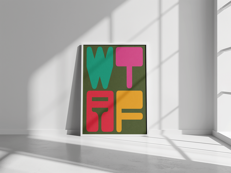 WTAF by Paul Scott. Printed Poster Artwork with large block letters spelling 'WTAF' in teal, pink, red, and yellow, leaning against a white wall near a window with sunlight streaming in.