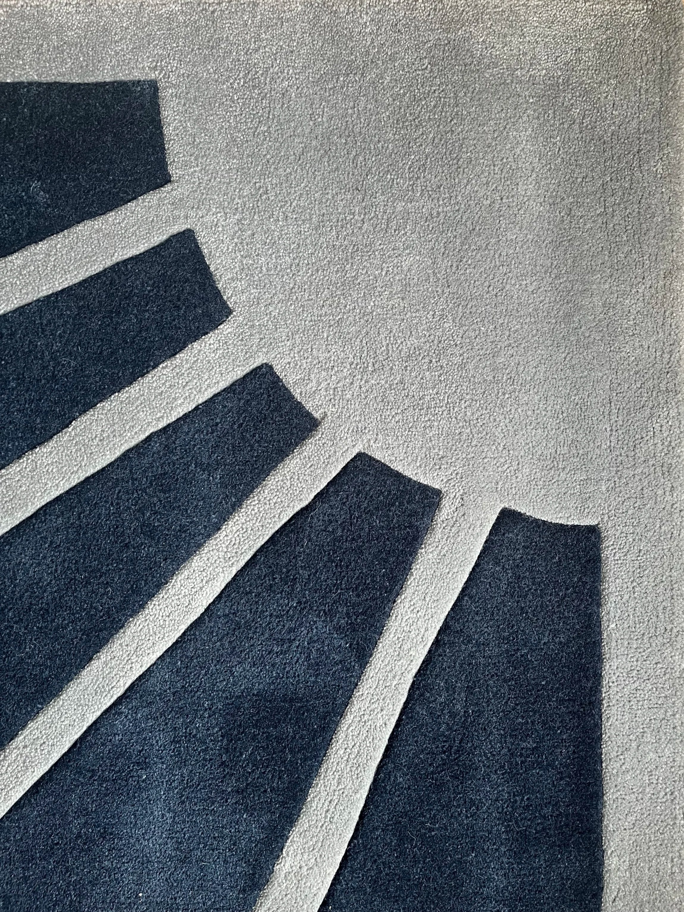 Close-up image of a black and white rubber or foam mat with geometric pattern.