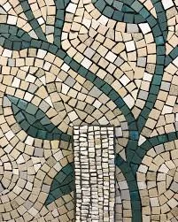 Close-up of a mosaic depicting a tree with beige and dark green tiles.