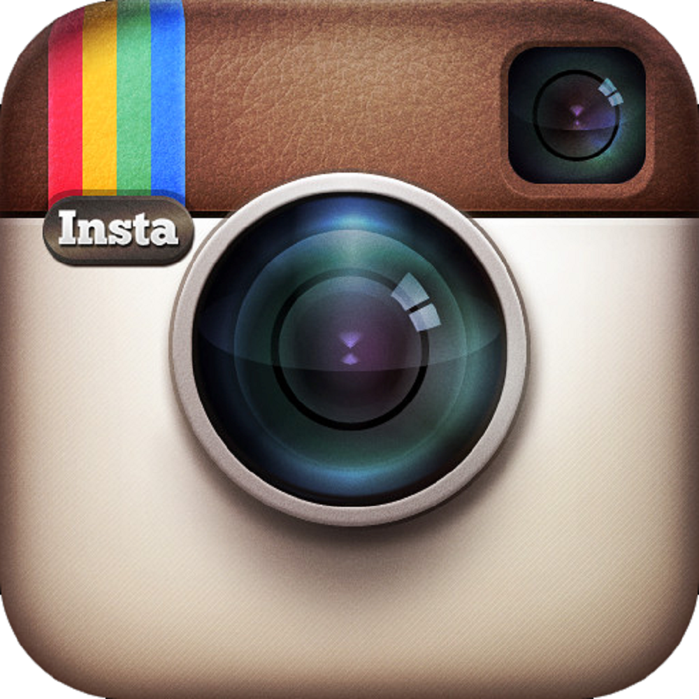 Close-up of Instagram logo, a retro camera with a rainbow stripe and lens.