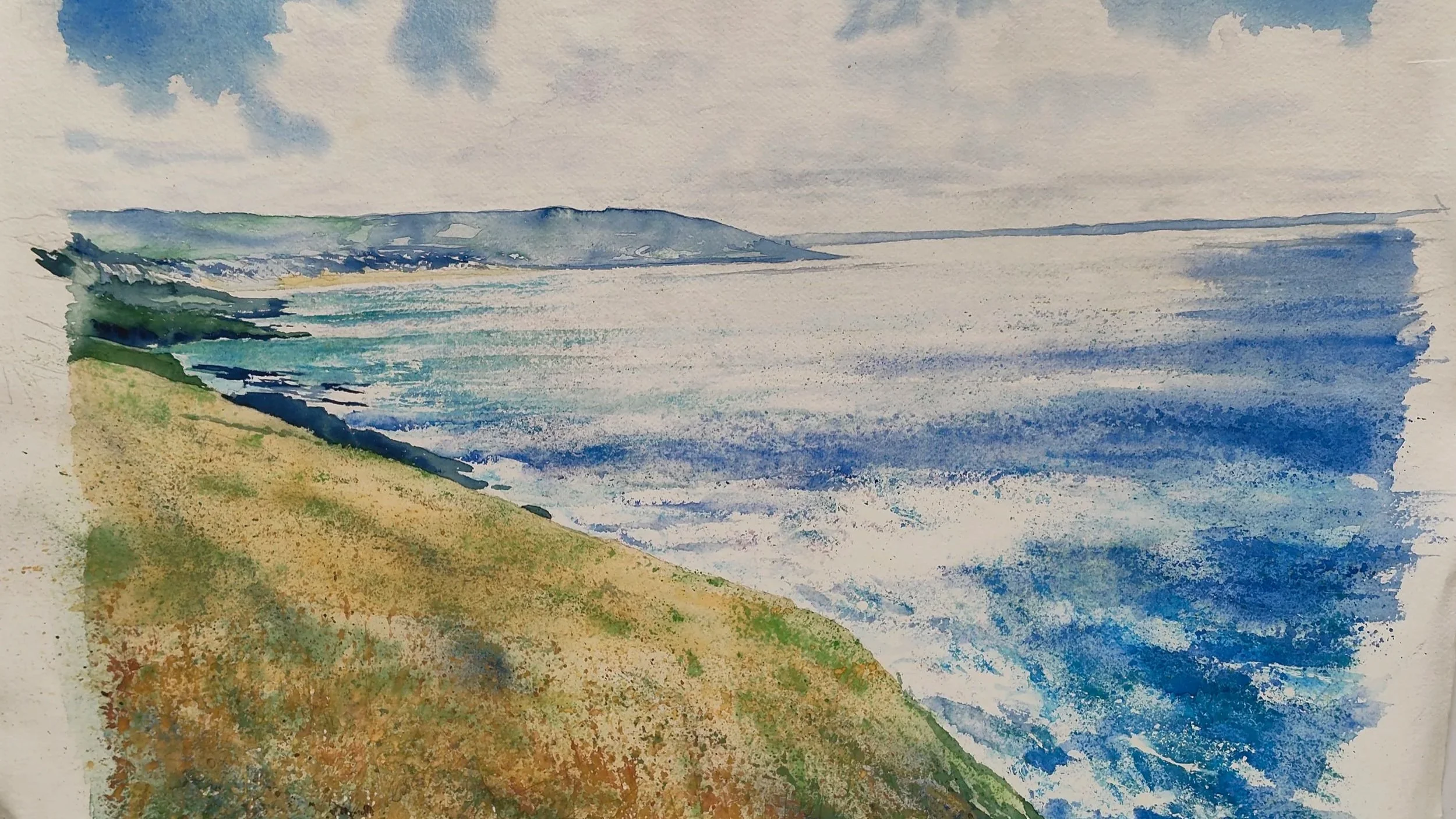 A watercolor painting of a coastal scene with green grassy hill in the foreground, blue ocean waves, a distant landmass on the horizon, and a partly cloudy sky.
