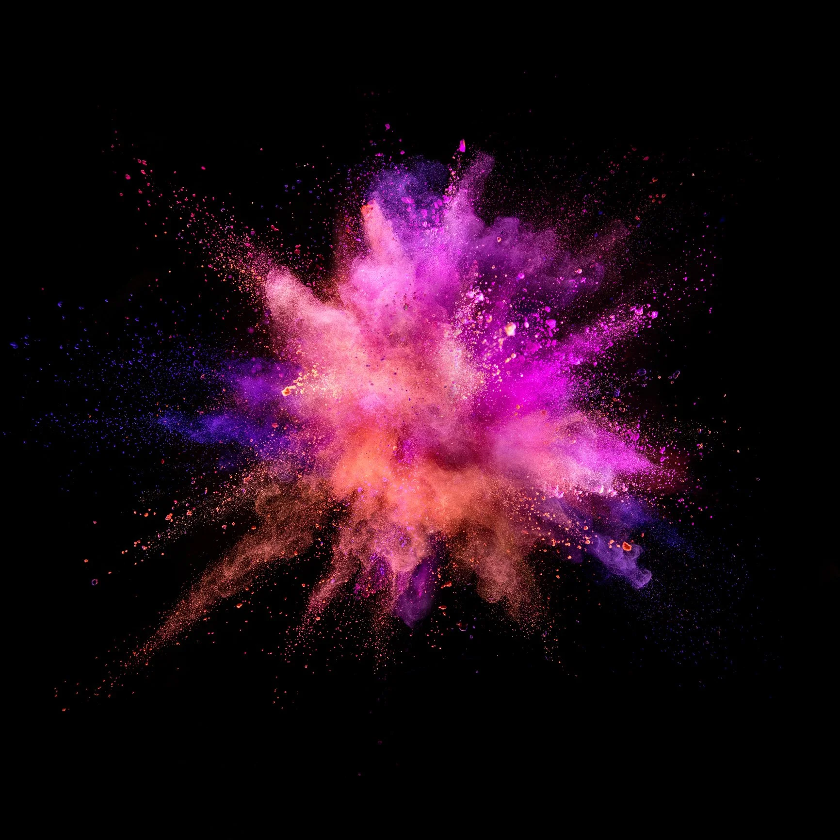 Colorful powder explosion on black background with pink, purple, and orange hues.