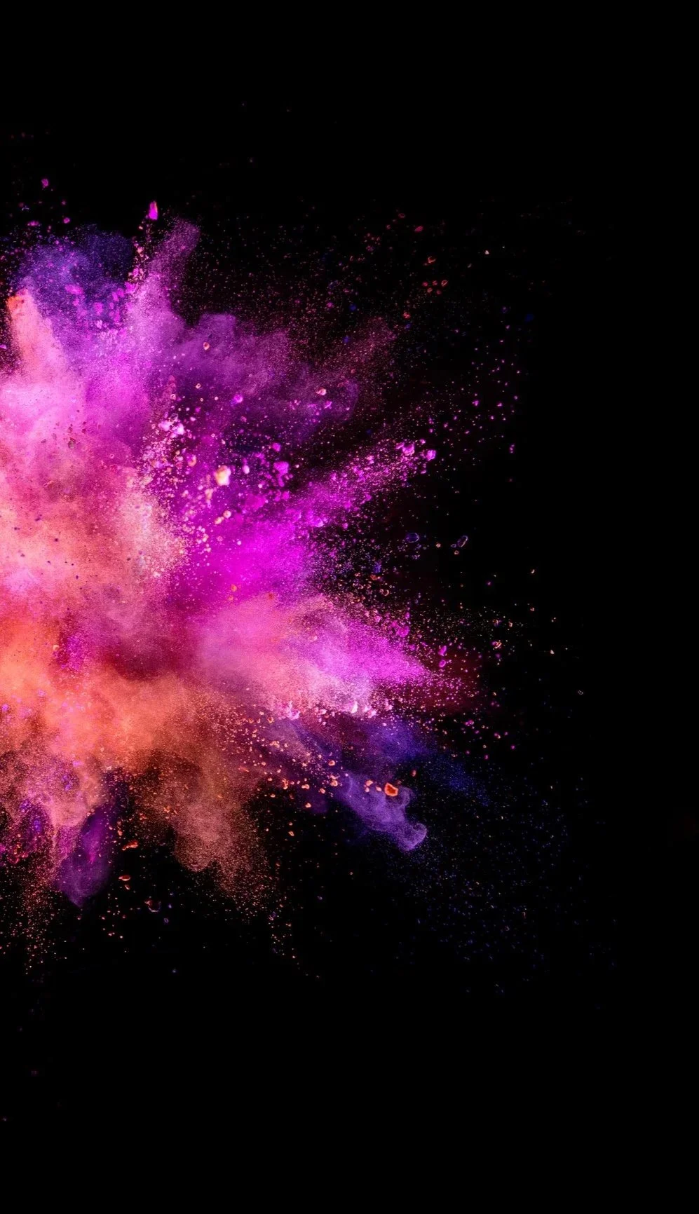 Bright pink, purple, and orange powder explosion on a black background.