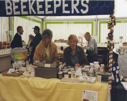 People shopping at a beekeepers booth at The Royal Highland Show.