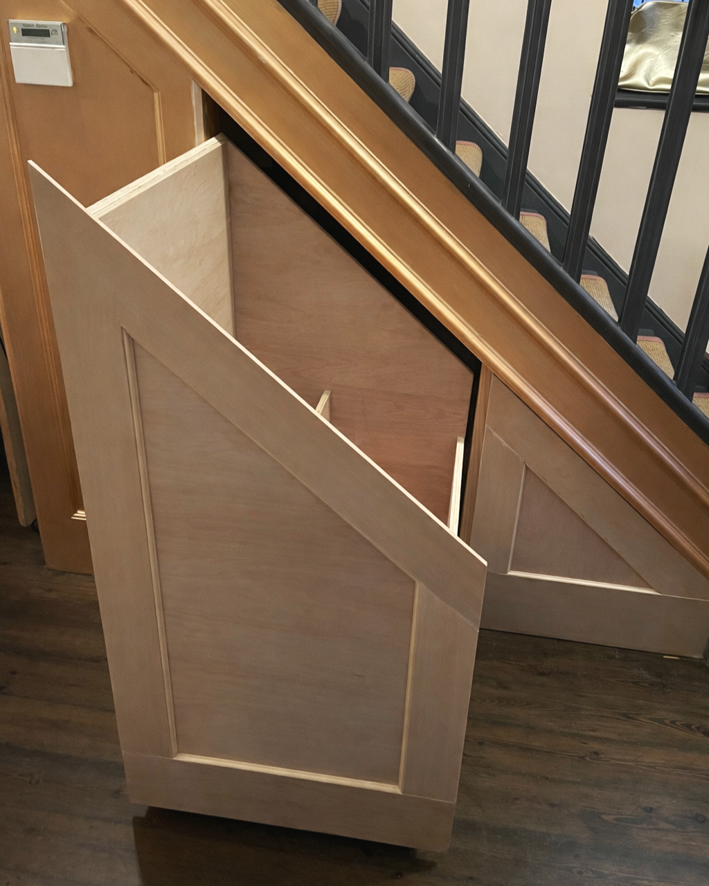 Understairs Storage Drawers: 
Plywood carcass, trimmed to reflect existing panelled effect of staircase. Installed on heavy duty runners with push to open mechanism