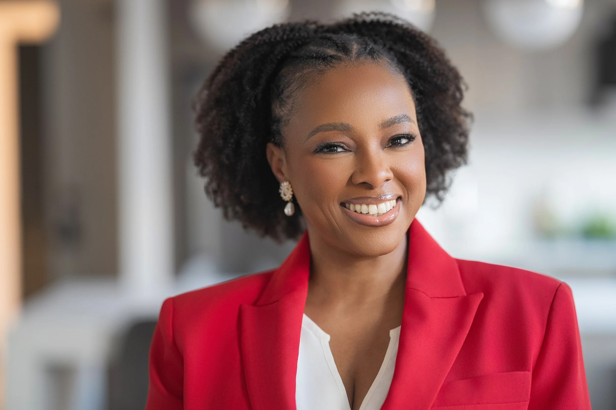 Portrait of Dr Marissa Toussaint in a red blazer