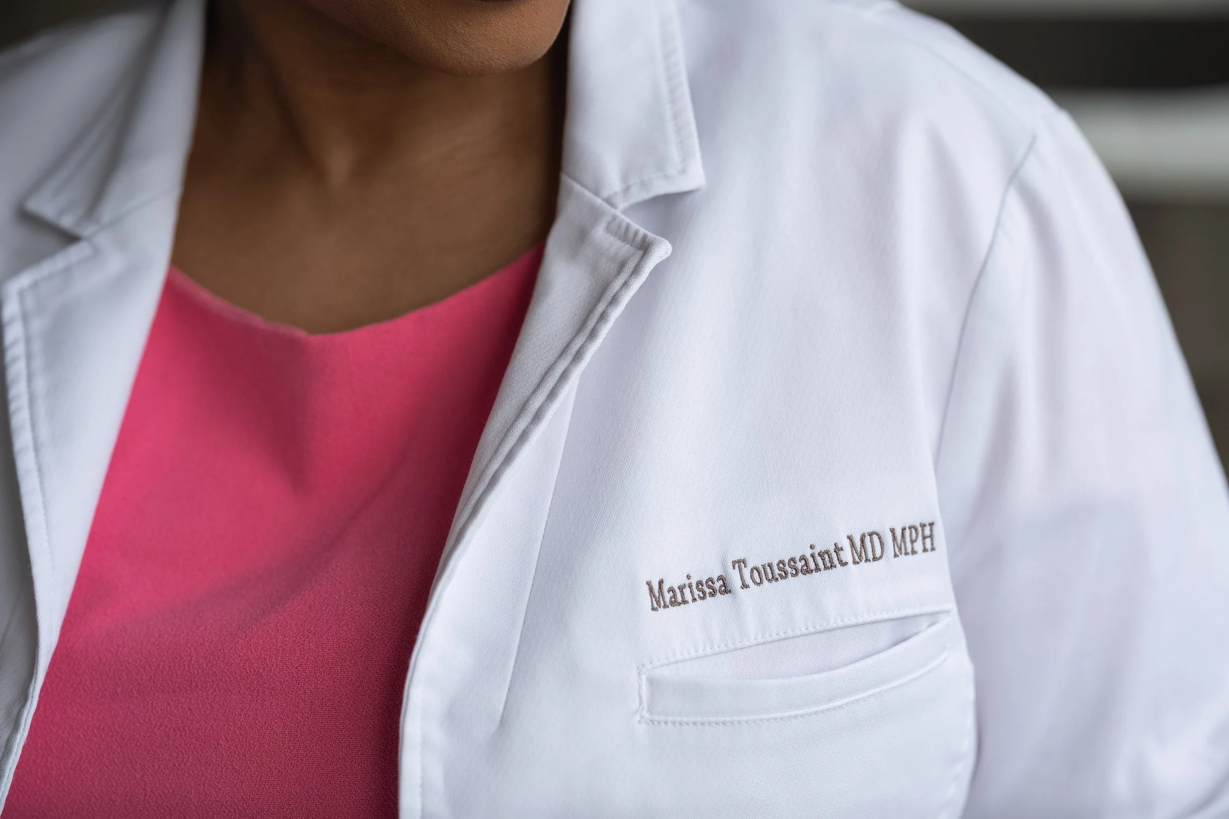 Detail photo of the lab coat of Dr. Marissa Toussaint, MD, MPH