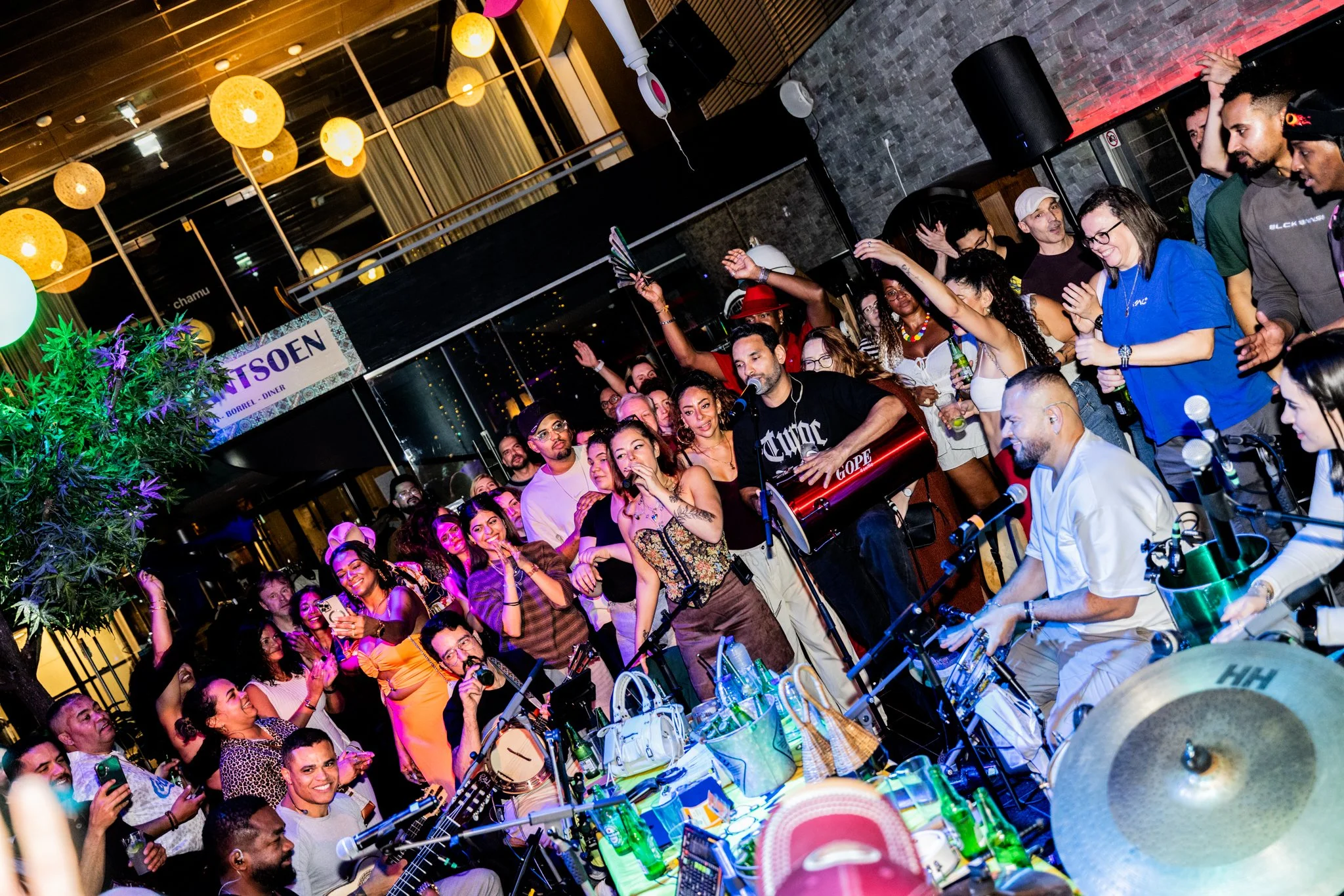 This is how Brazilians come together at a Roda de Samba. A lively party scene with everyone dancing, singing, and enjoying the Roda de Samba, shoulder to shoulder with the band
