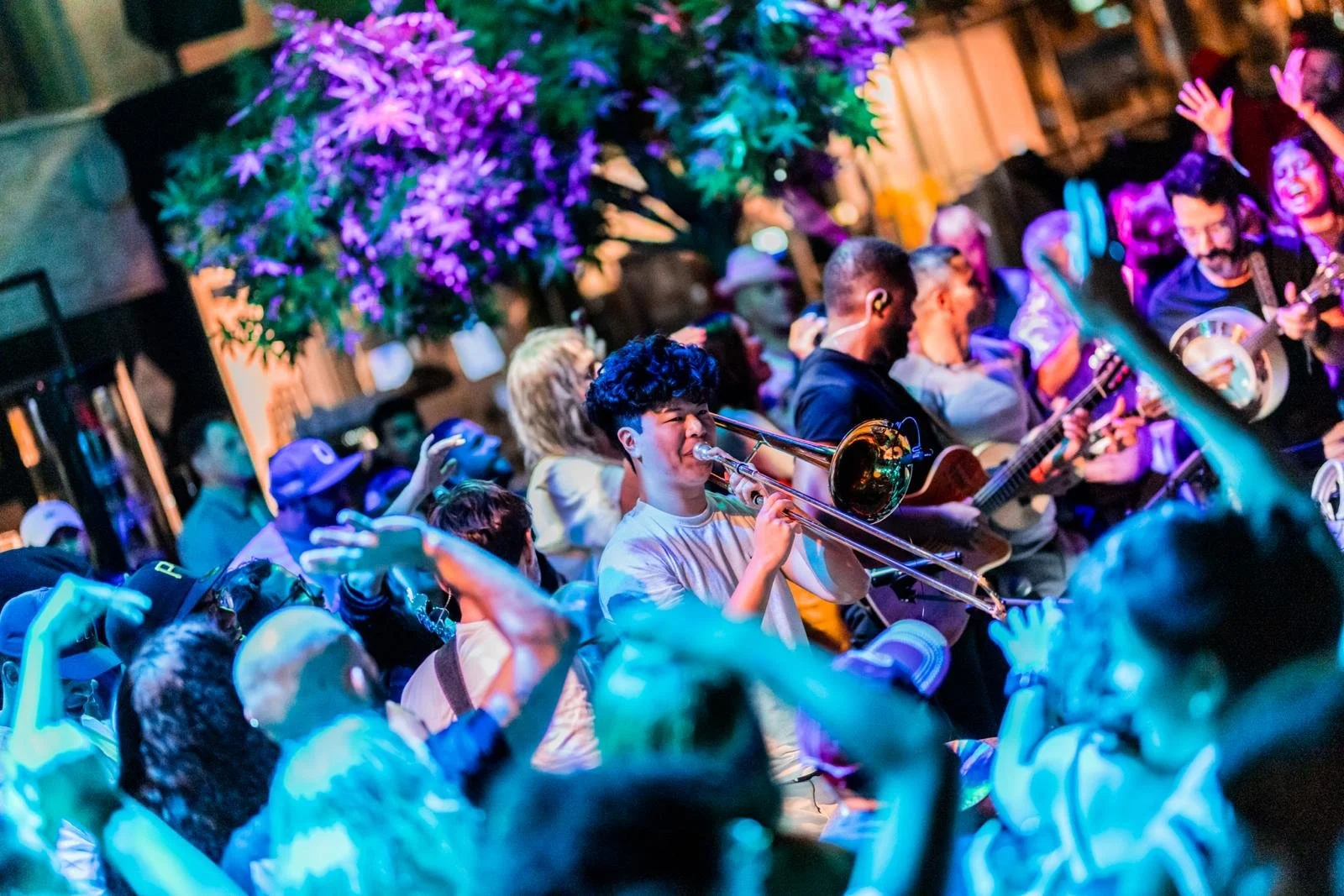 Samual Wang playing trombone at our iconic Roda de Samba & Feijoada Sunday. With people dancing, singing. Come enjoy life the Brazilian way