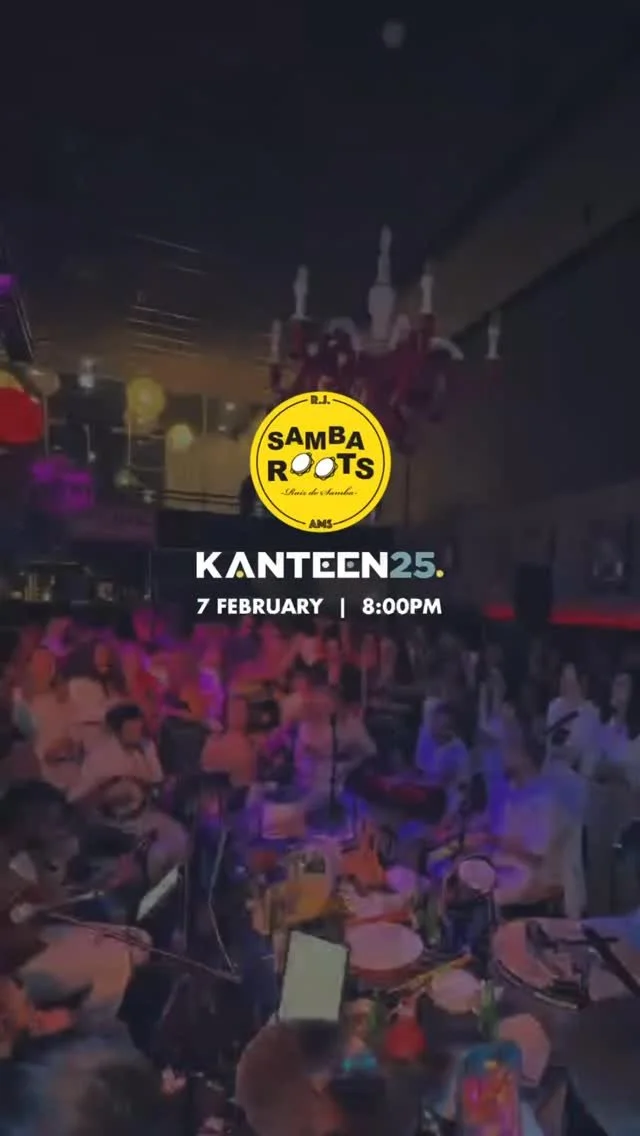 Nighttime indoor event with people sitting at tables, live music setup, and a sign promoting Samba Roots at Kanteen 25 on February 7th at 8:00 PM.