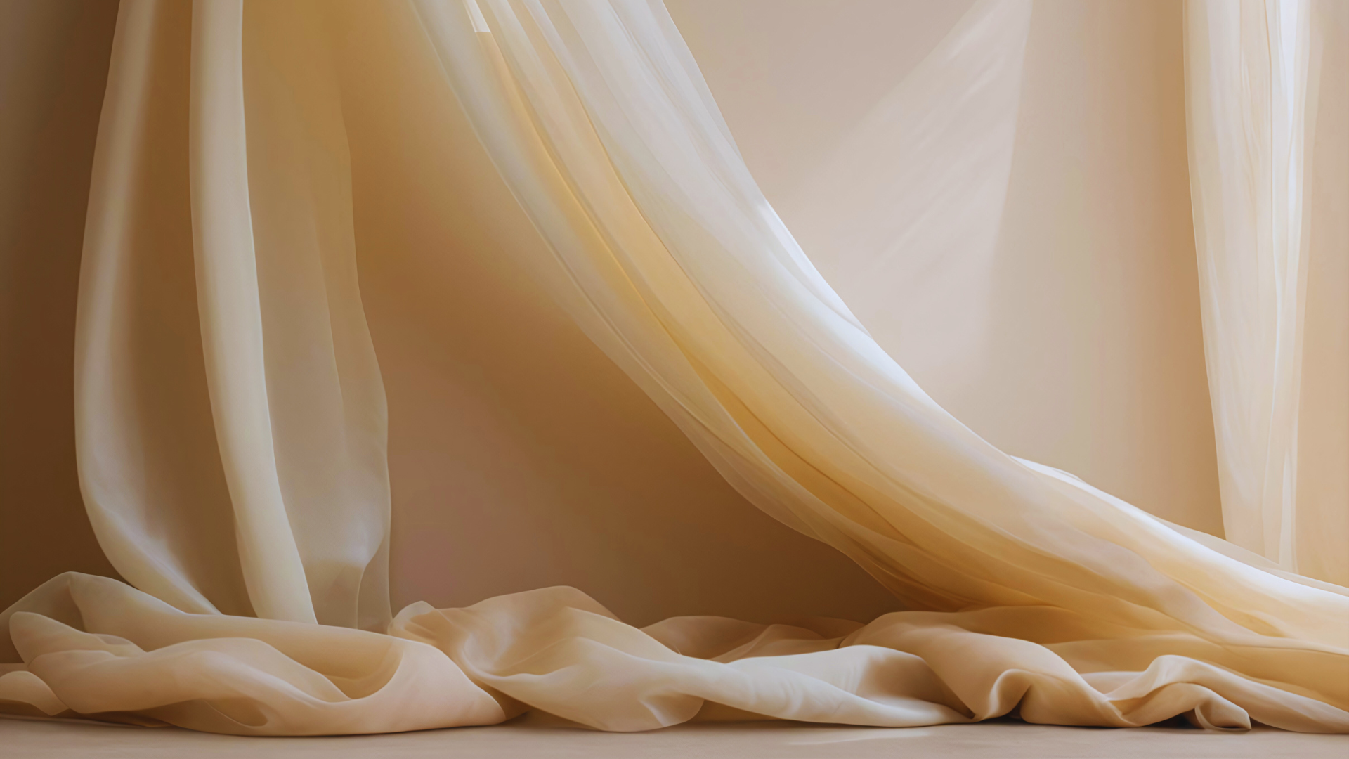 Close-up of cream-colored draped fabric with soft folds and flowing texture.