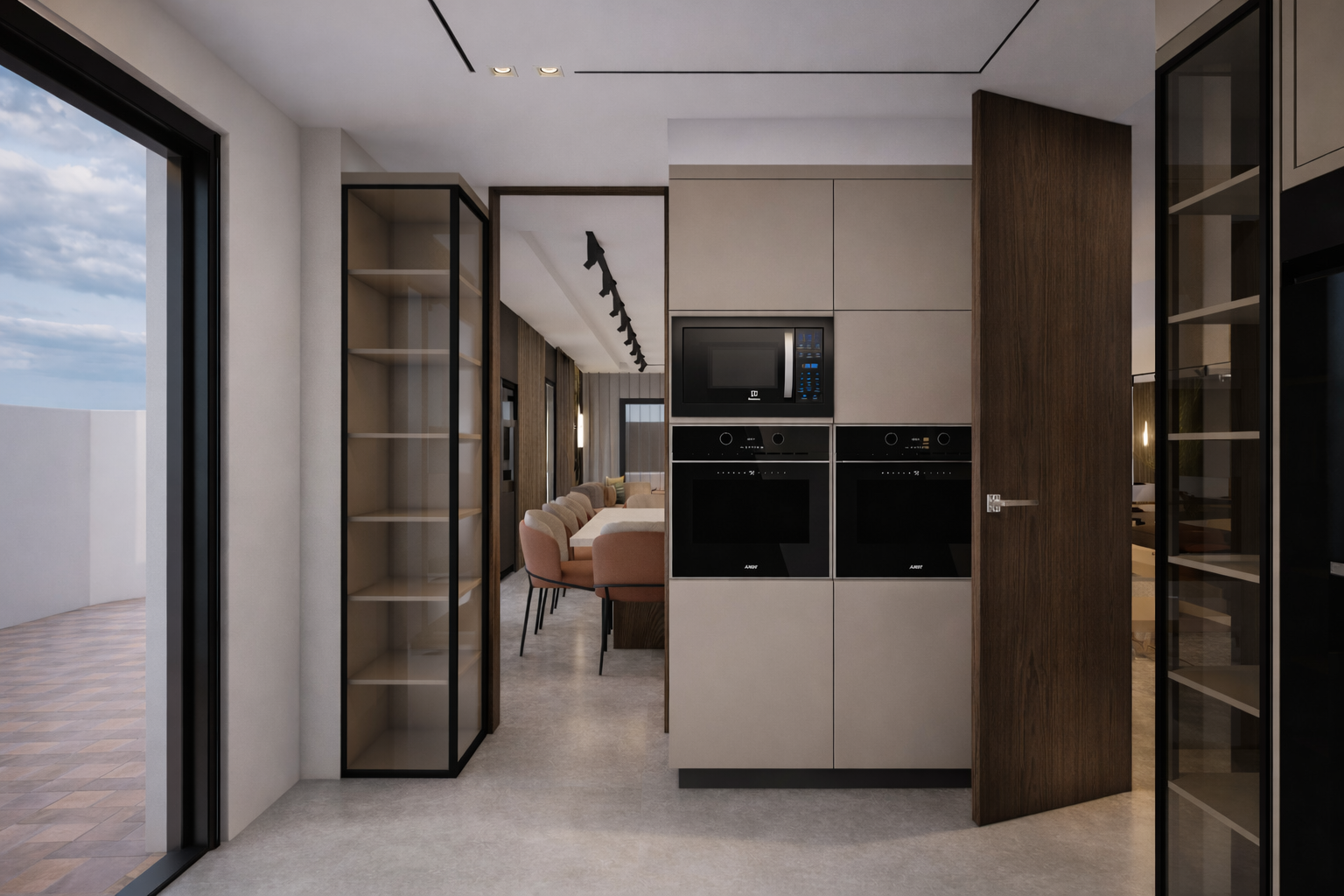 Intérieur d'une cuisine moderne avec four, micro-ondes, et étagères en bois, vue vers une salle à manger avec des chaises roses.