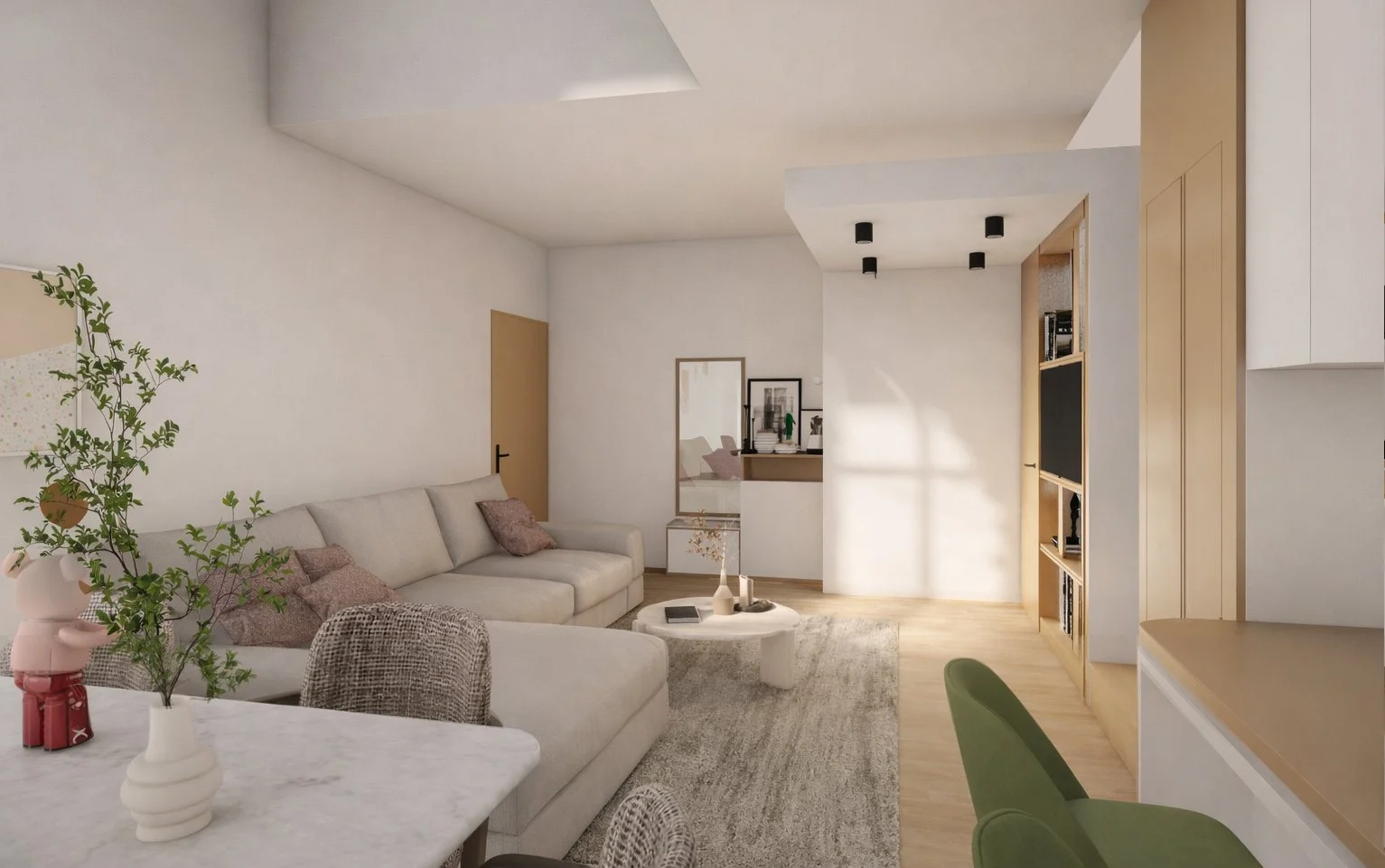 Salon moderne avec canapé beige, table basse ronde, étagère en bois, mur blanc, décoration minimaliste, plantes vertes, tapis gris, cuisine visible en arrière-plan.