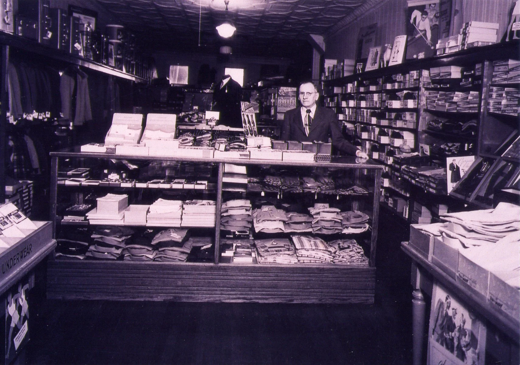 Williams clothing store with employee standing at counter ready to help
