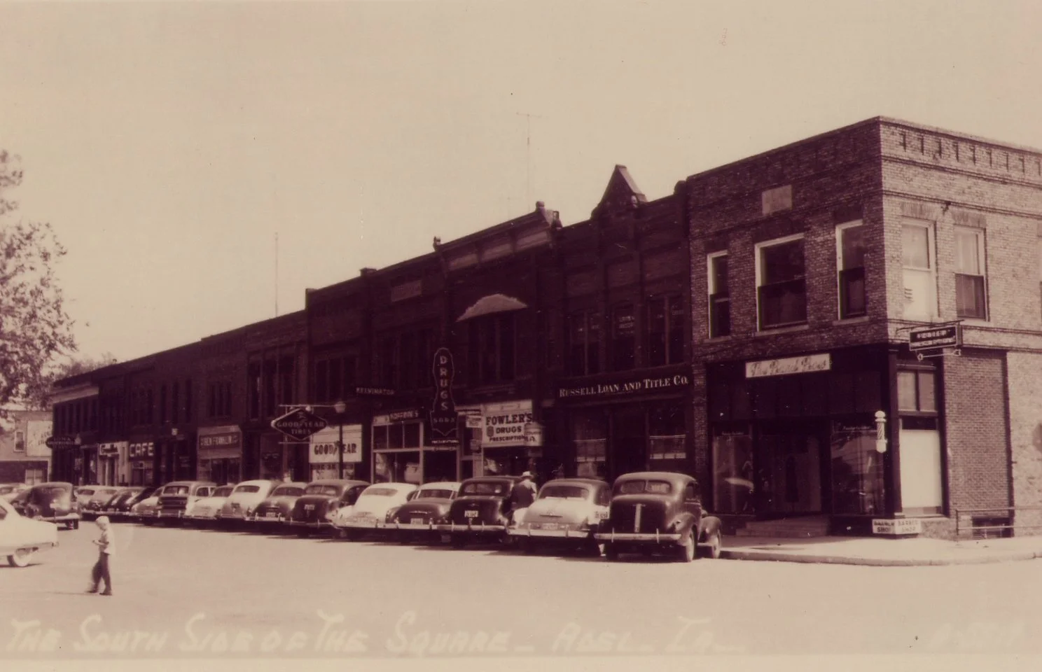 Main Street on square from early 1900s based on the type of car parked in front. 