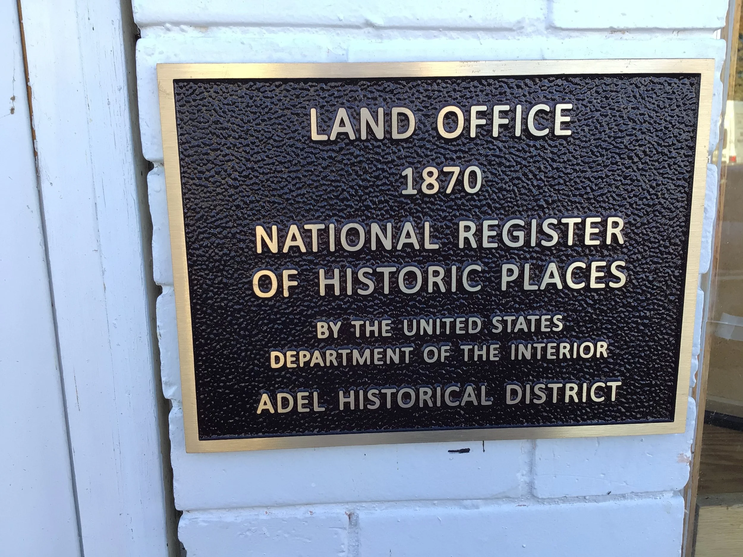 Plaque noting the building is on national historic registry and was first called Land Office and built in 1870 