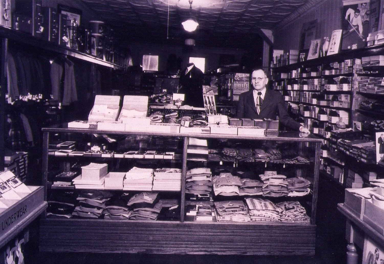 Older clothing store with a man standing at the counter