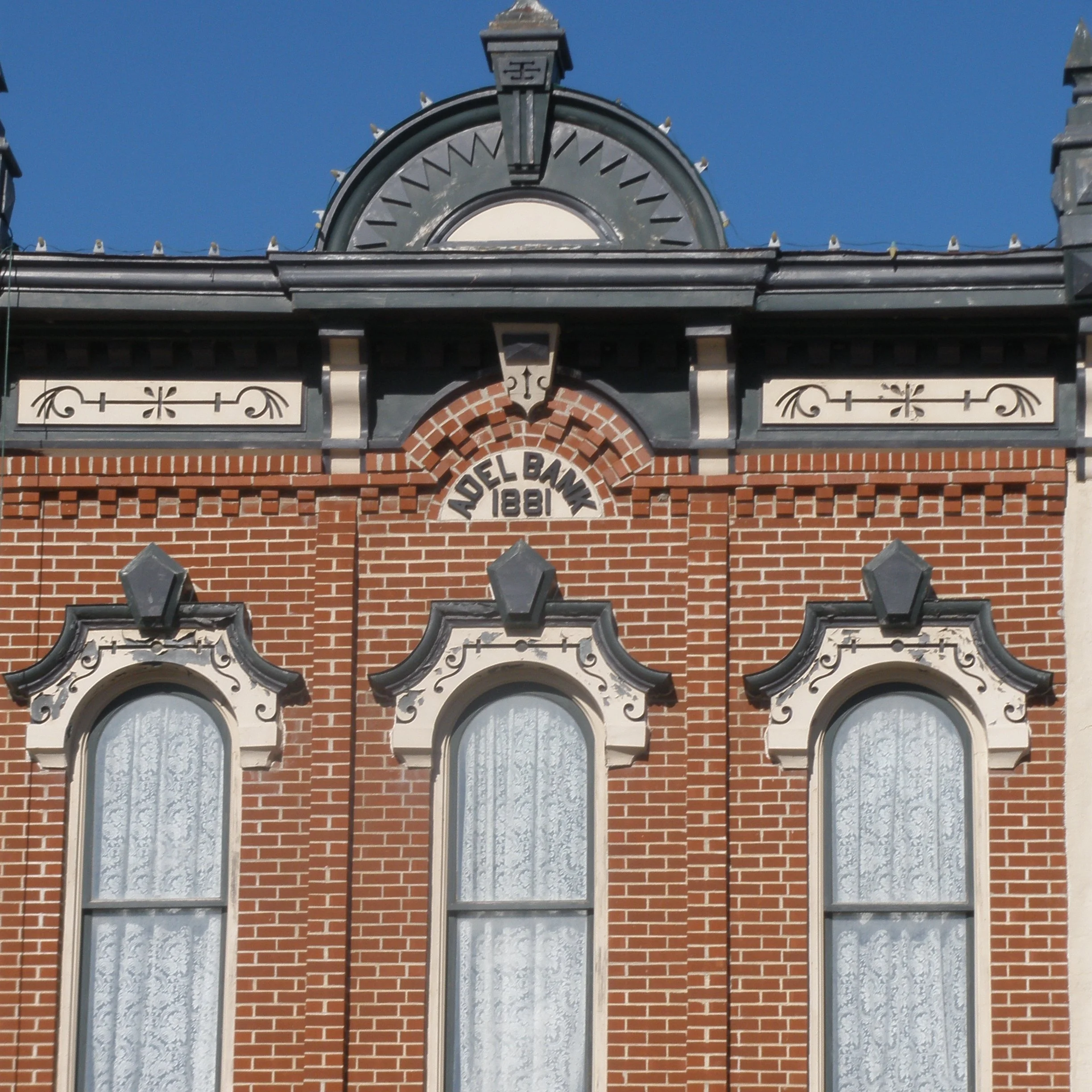 Front of the Adel Bank building with 3 long windows and Adel Bank 1881 at top