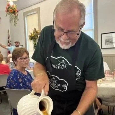 Man pouring tea in Adel Historical Museum uniform