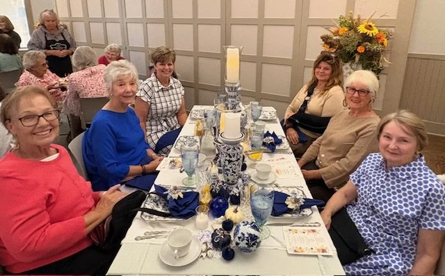 Six female guests around a blue and white decorated table