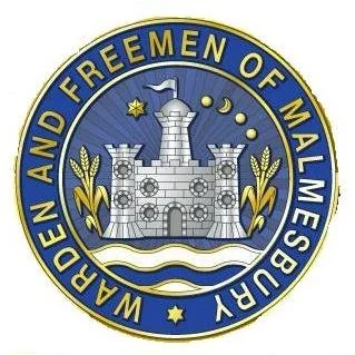 Seal of the Warden and Freedmen of Malmesbury, featuring a stone fortress with a flag, surrounded by wheat, stars, and moon symbols, and the inscription "Warden and Freedmen of Malmesbury".
