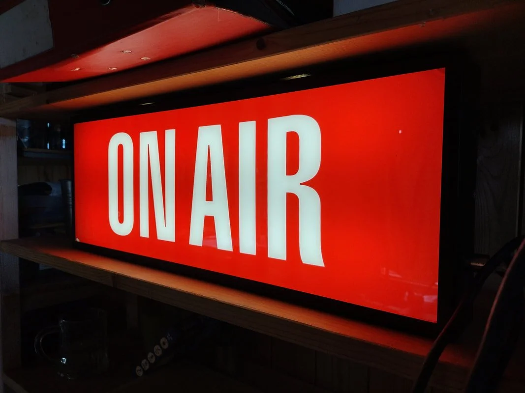 Red illuminated sign with white text reading "ON AIR."