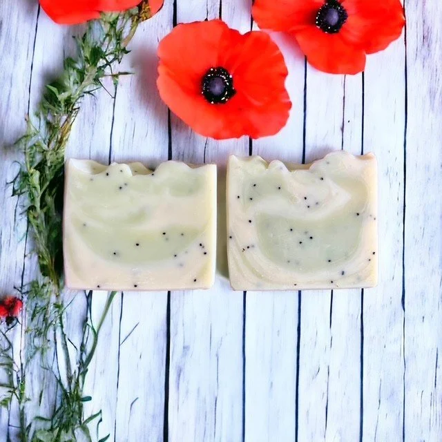 Poppy and tea tree handmade soap bars with green clay and poppy seeds styled with red poppy flowers