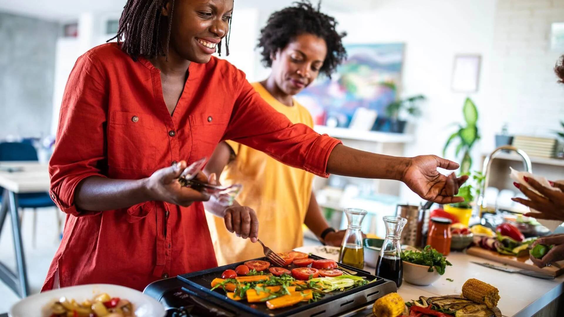 two woman cooking healthy weight loss meals together