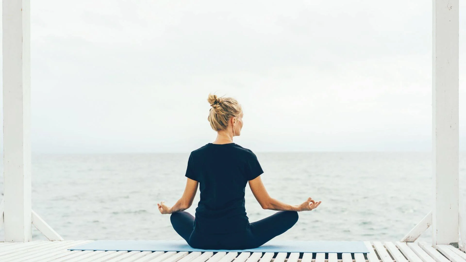 women looking out at the water while doing yoga