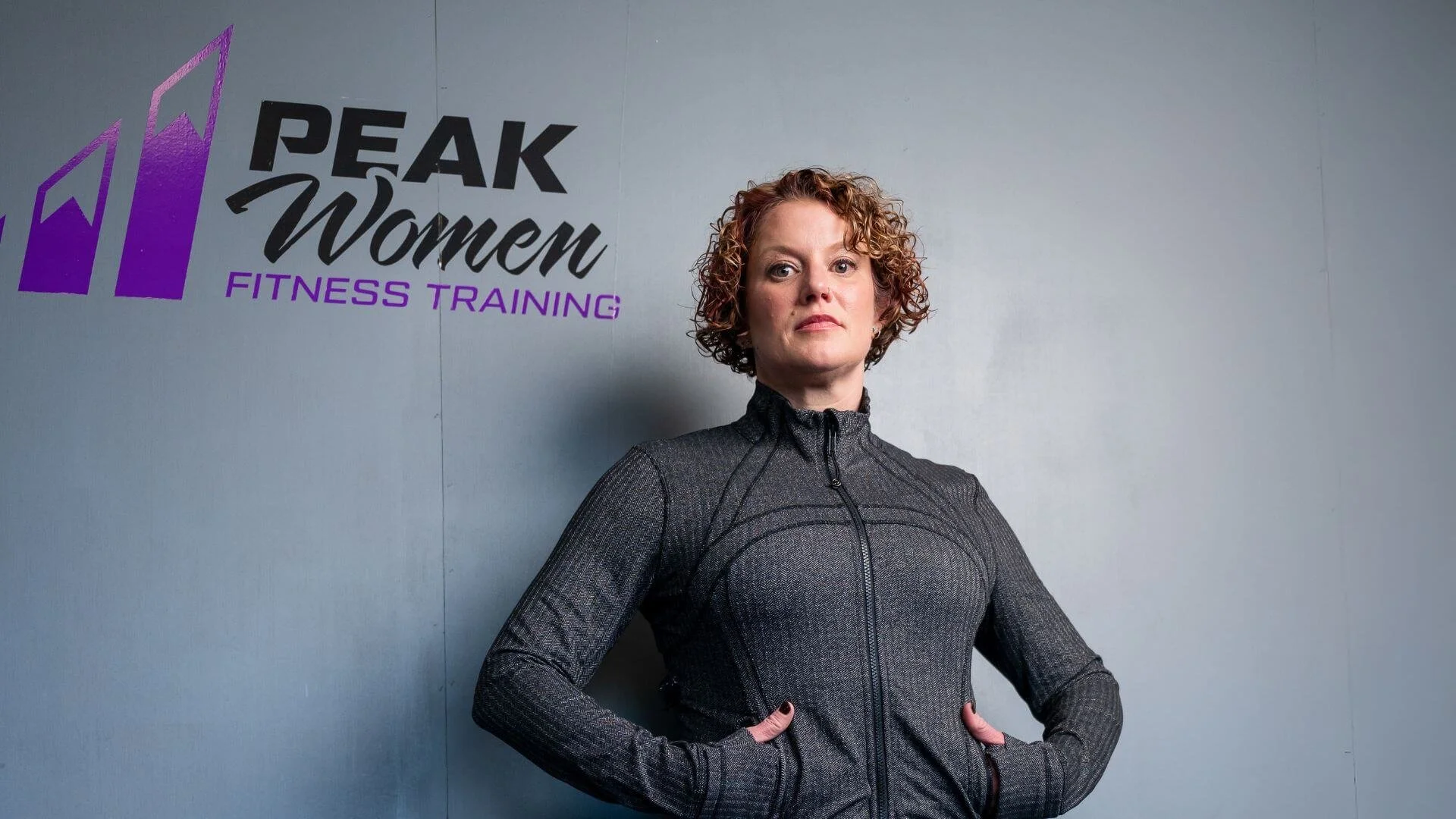 lissa, standing in front of the peak women logo
