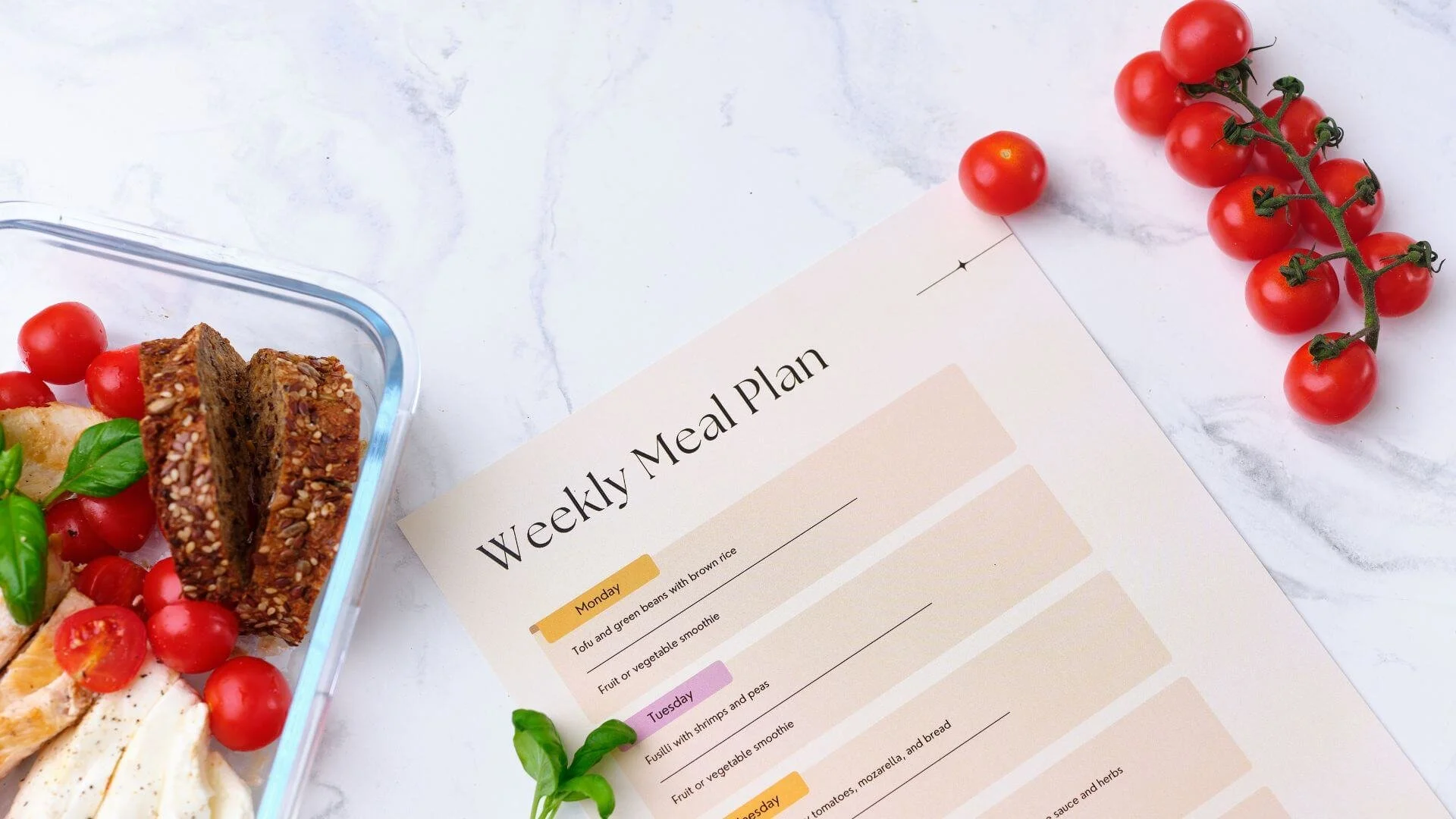 food on a table with a paper weekly meal plan