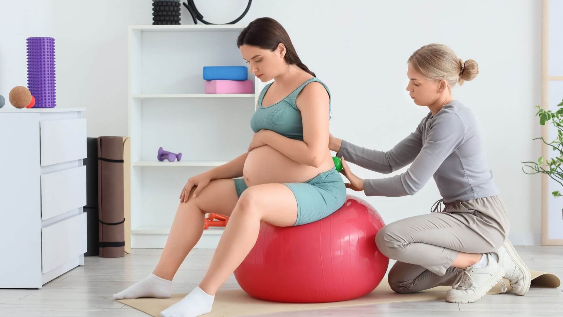 pregnant woman working out with a female personal trainer