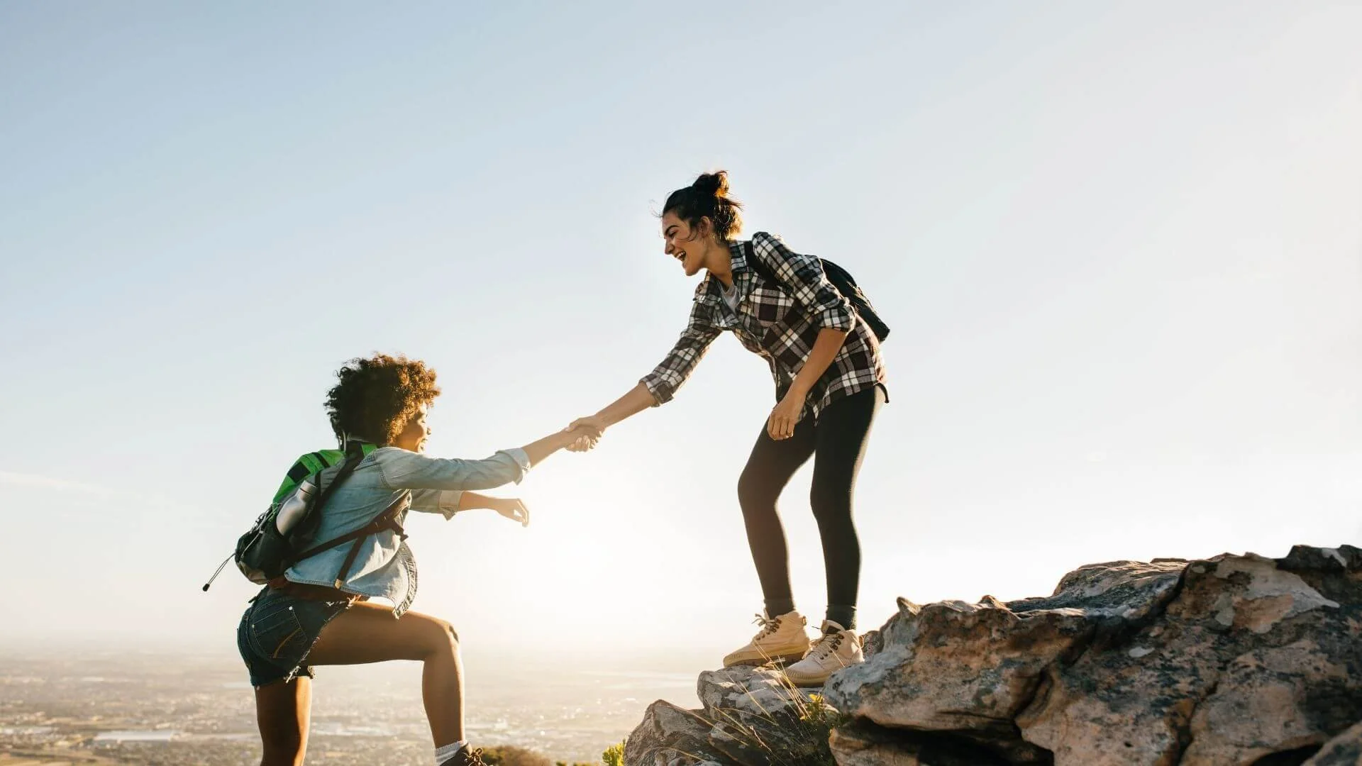 two women having fun while hiking to make working out fun