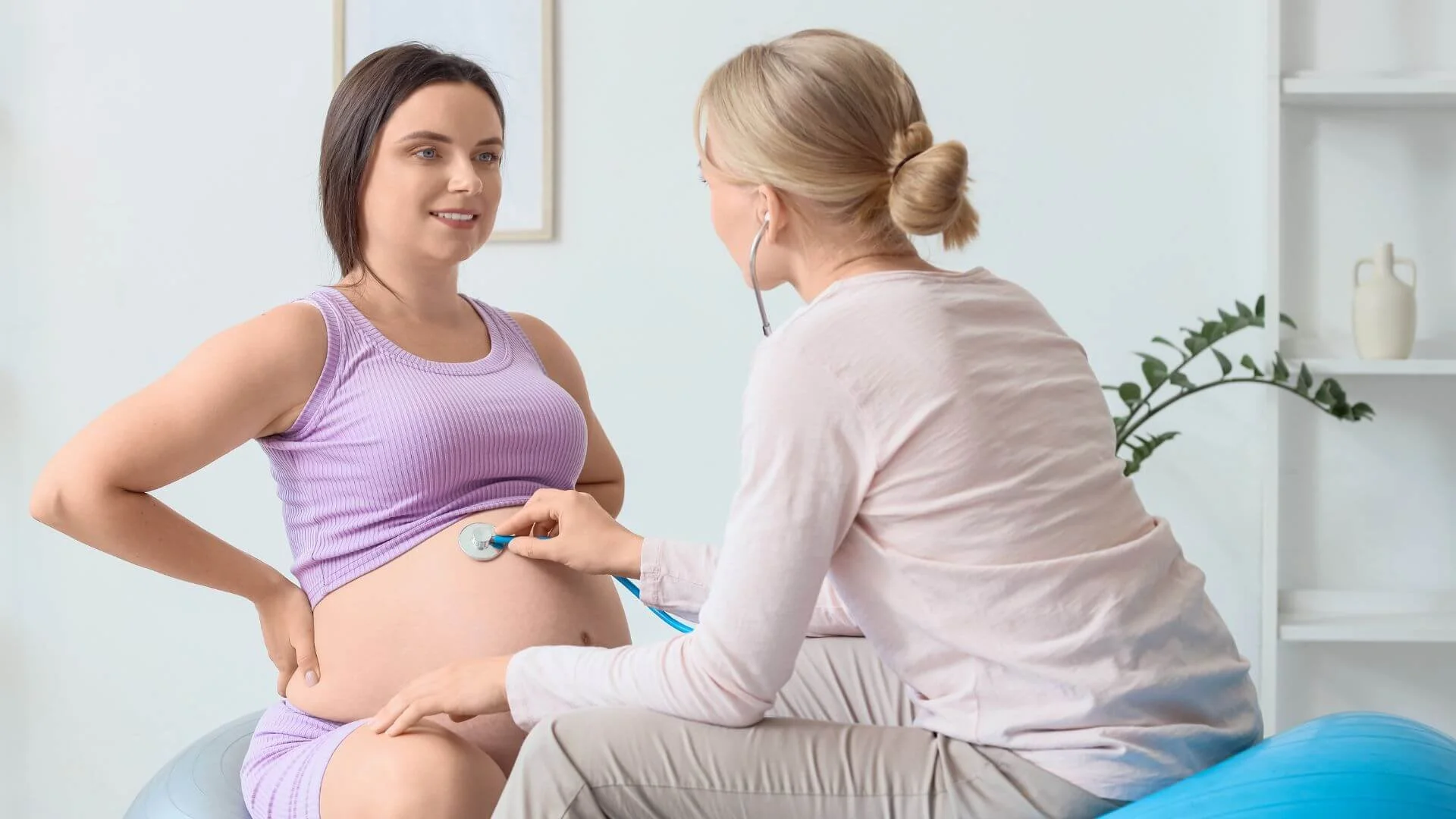 pregnant woman getting checked on by a doctor