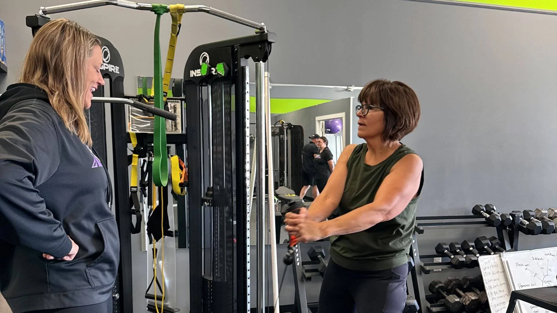 client exercising at peak women with female personal trainer
