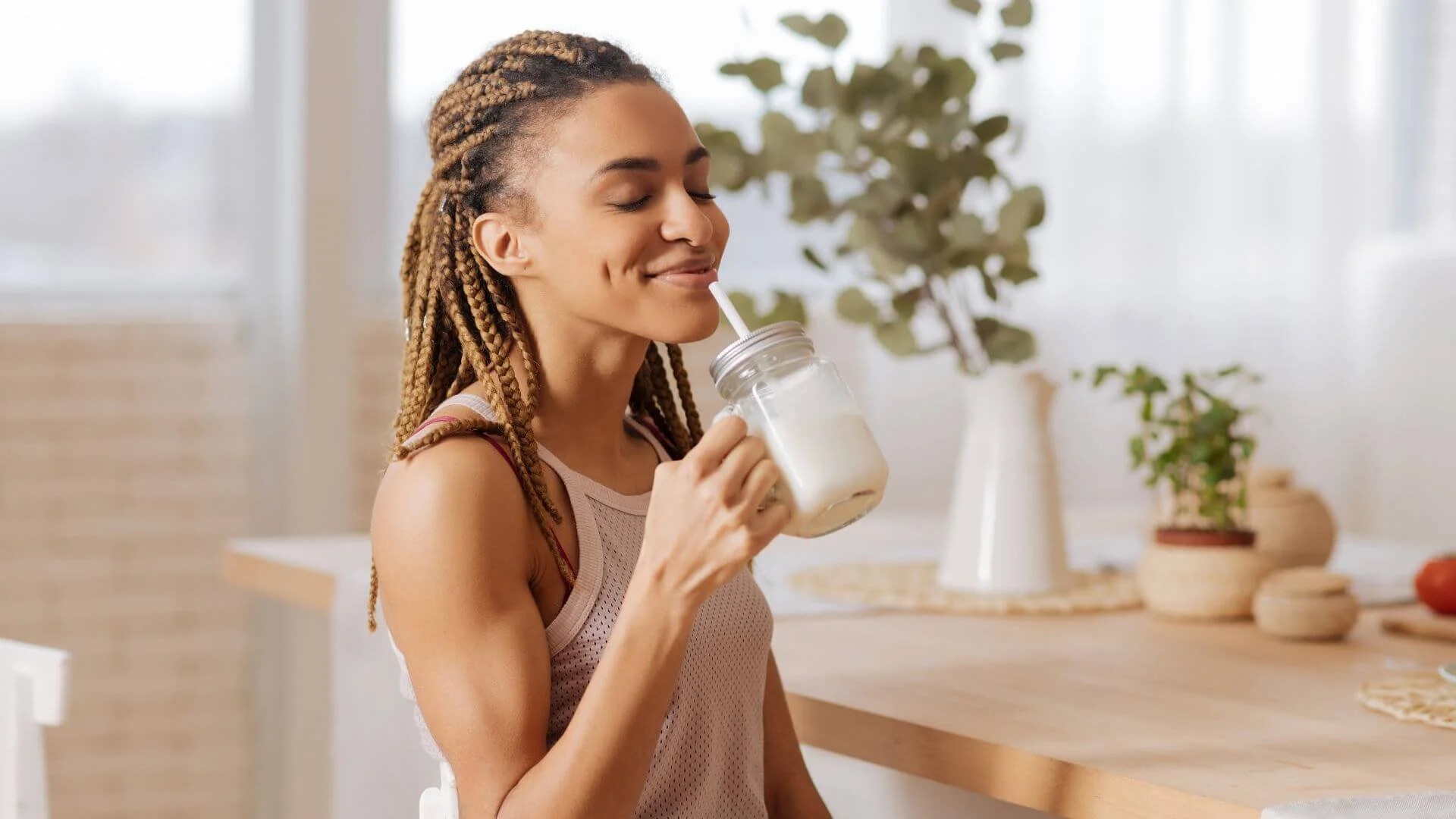 woman drinking a healthy shake to fuel up before exercising
