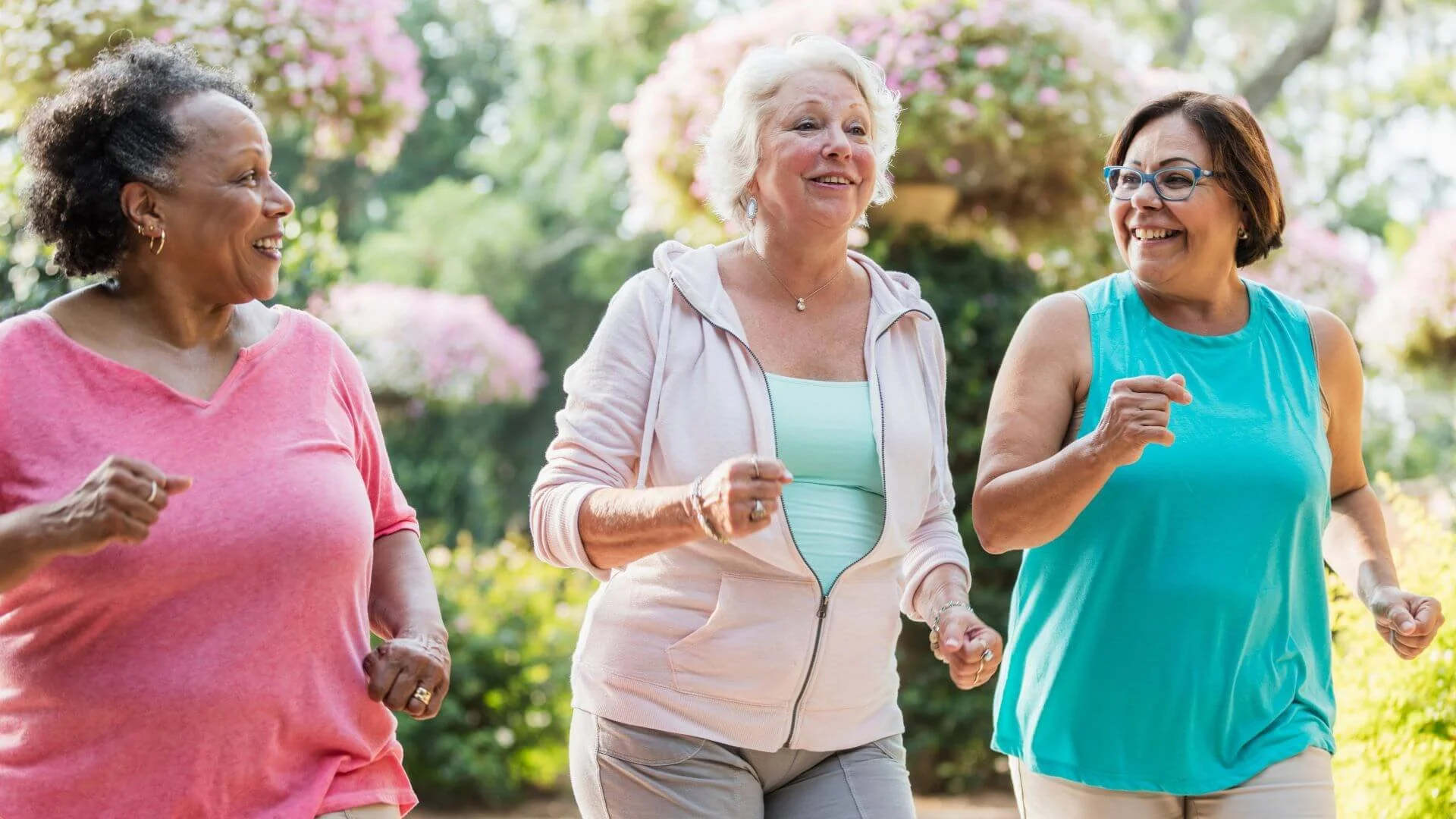 3 smiling women walking and talking having fun doing fitness their way