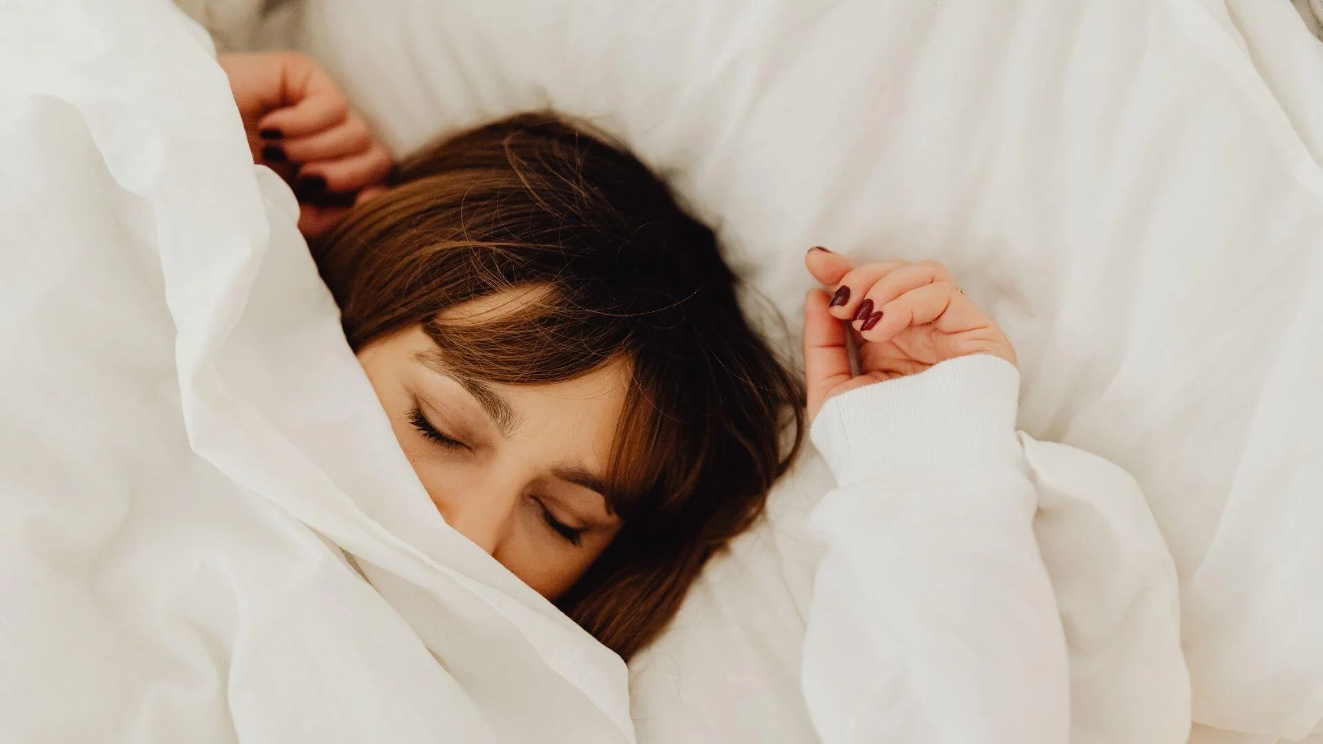 woman under the covers sleeping