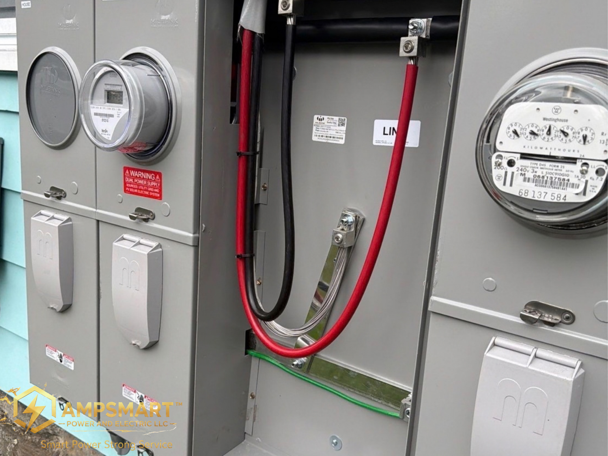 Close-up of electrical service panel with meters, circuit breakers, and colored wiring, including red, black, and green cables. The panel is gray with labels and warning notices visible.