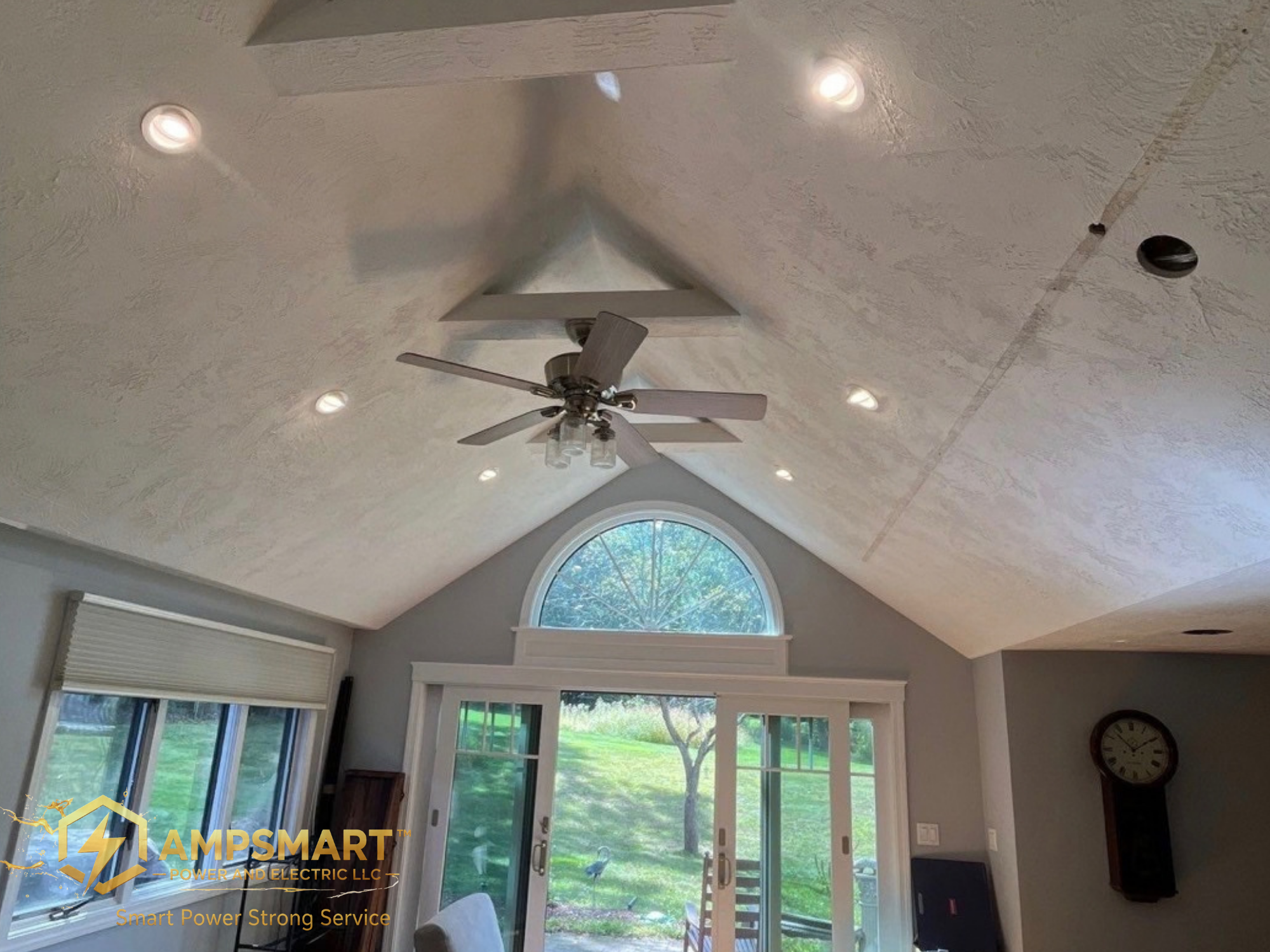 A ceiling with recessed lighting, a ceiling fan, a window with blinds, and a sliding glass door leading to a backyard with greenery and a turkey