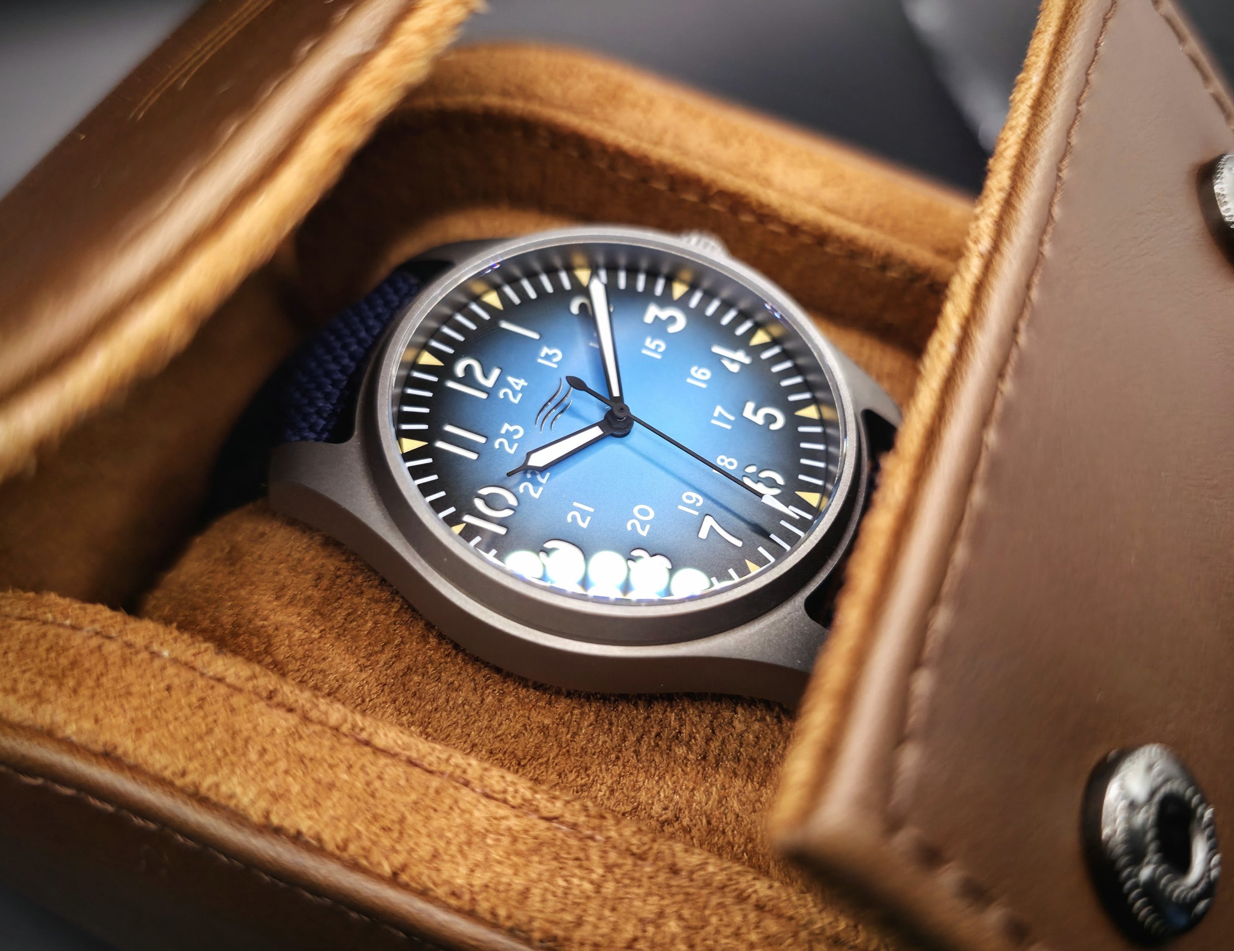 Beautiful blue Vanguard field watch in a brown leather case