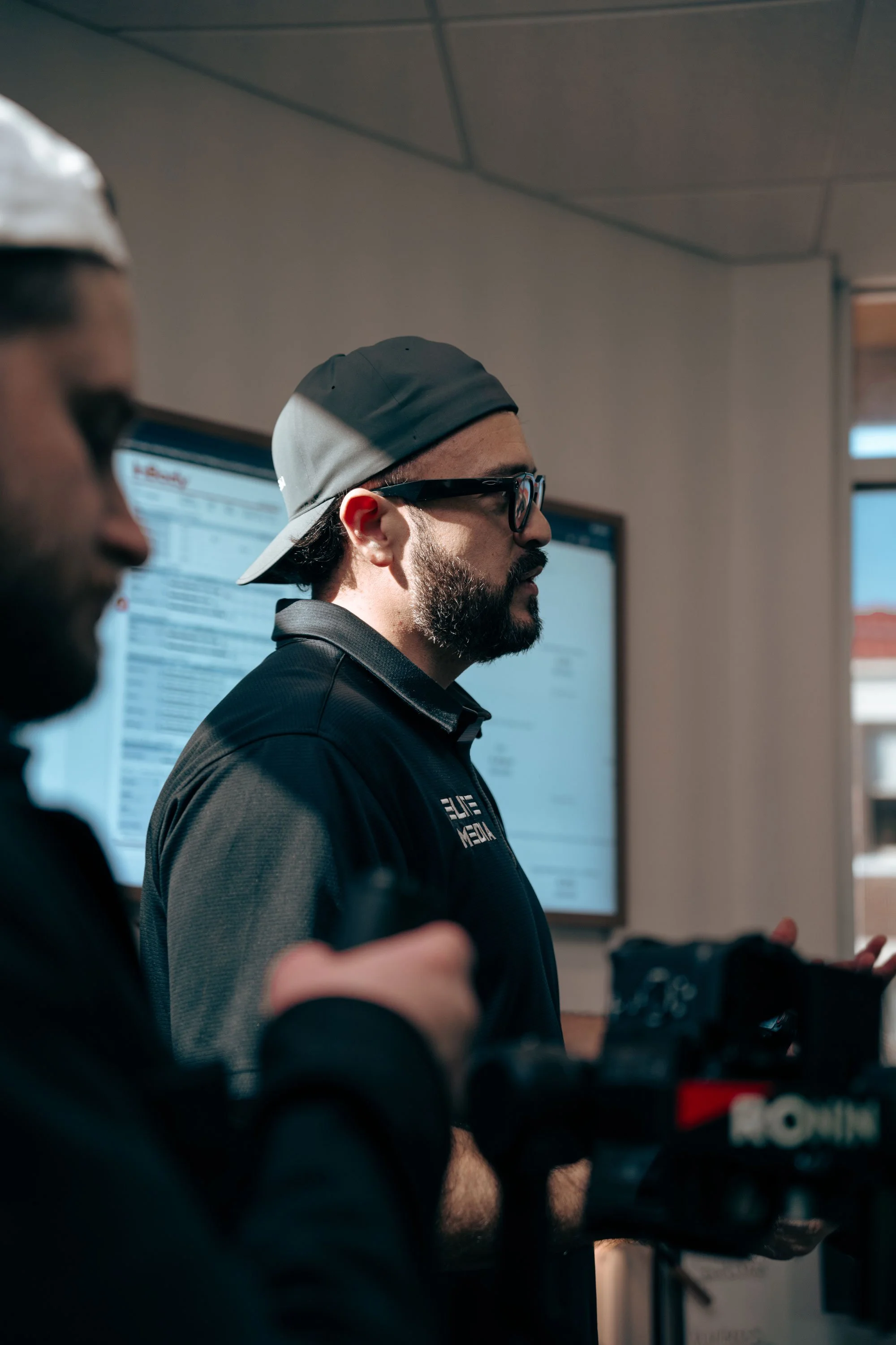 Founder pf Elite media listening to client while on a shoot