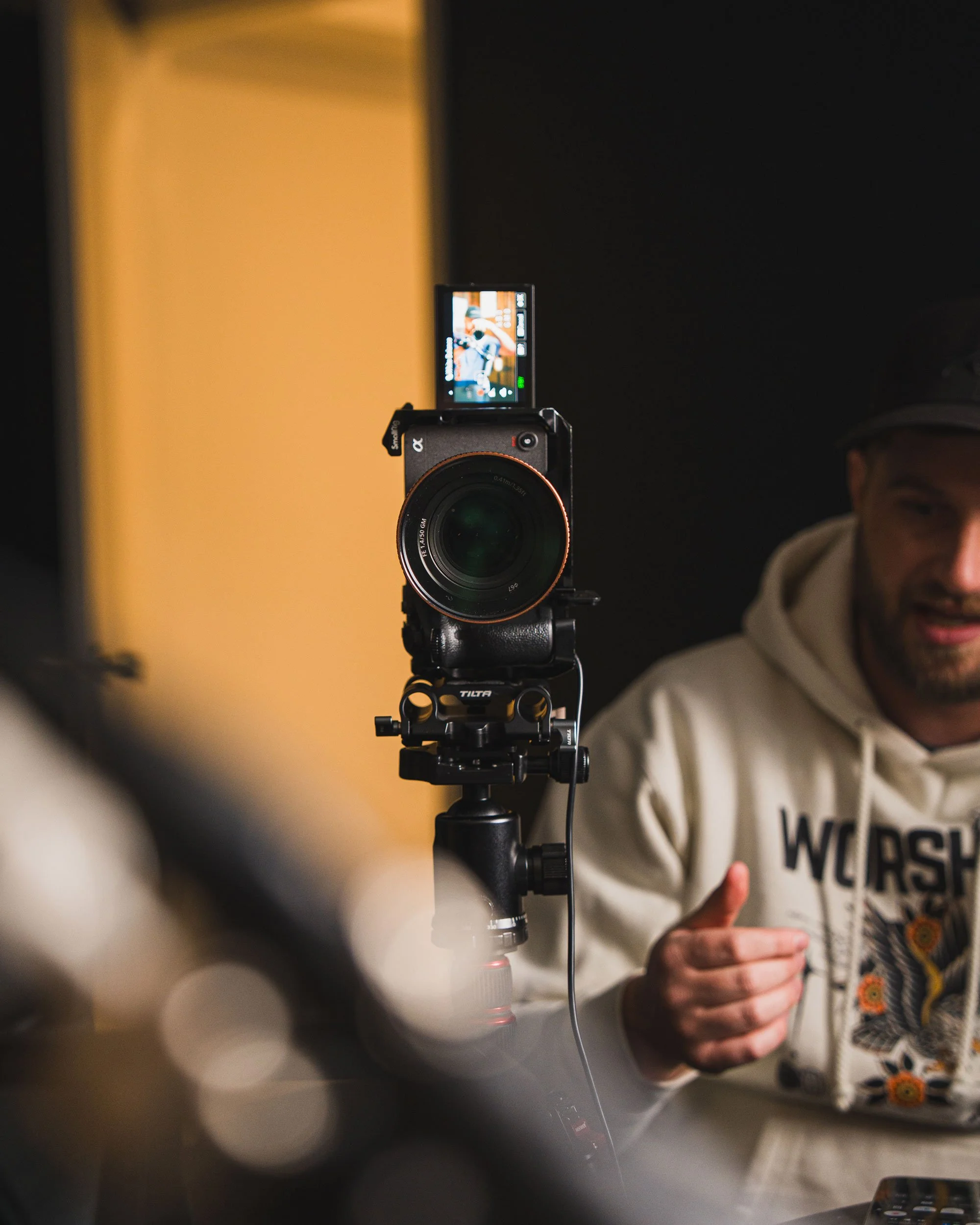 Elite Media staff member explaining behind the scenes of a setup for filming.