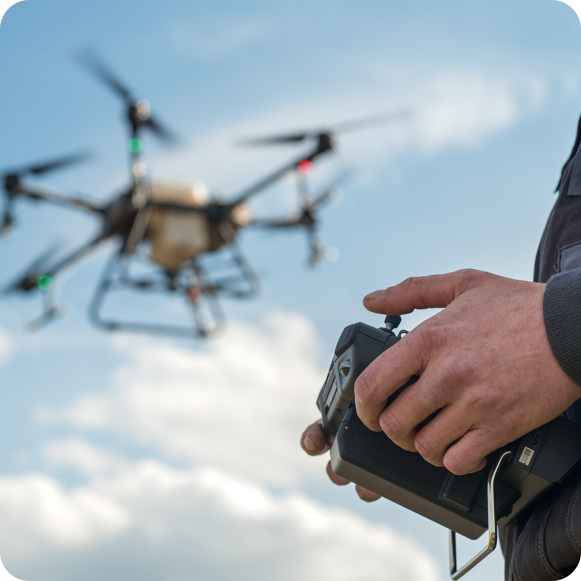 Drone Academy student operating a professional multirotor drone with remote controller during hands-on STS practical flight training – real-world UAV pilot skills development in a certified aviation environment.