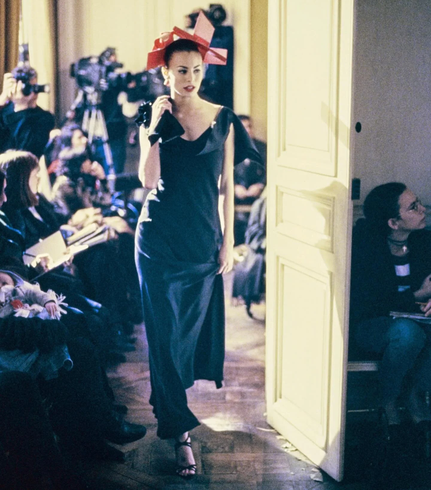 John Galliano A/W 1994 &ldquo;Black - Sao Schlumberger&rdquo; star bias-cut satin-backed crepe gown, featuring a cowl neckline and silk flowers to the shoulder is available to purchase at The Fashion Arbiters.

The collection consisted of only eighte