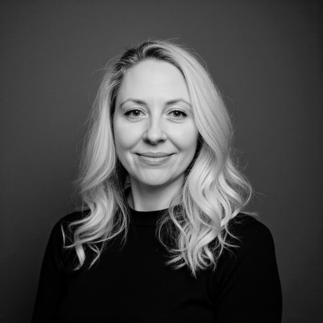Michelle Luchansky, brand strategist and founder of Pretty Damn Creative, black and white headshot.