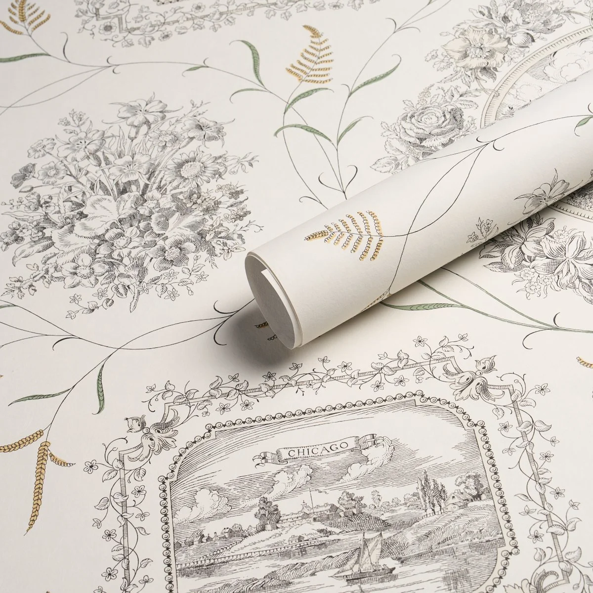 Schumacher Century Scenic Toile wallpaper in Black, unfurled on a roll to show the Chicago vignette and green vine accents, SKU 5018410